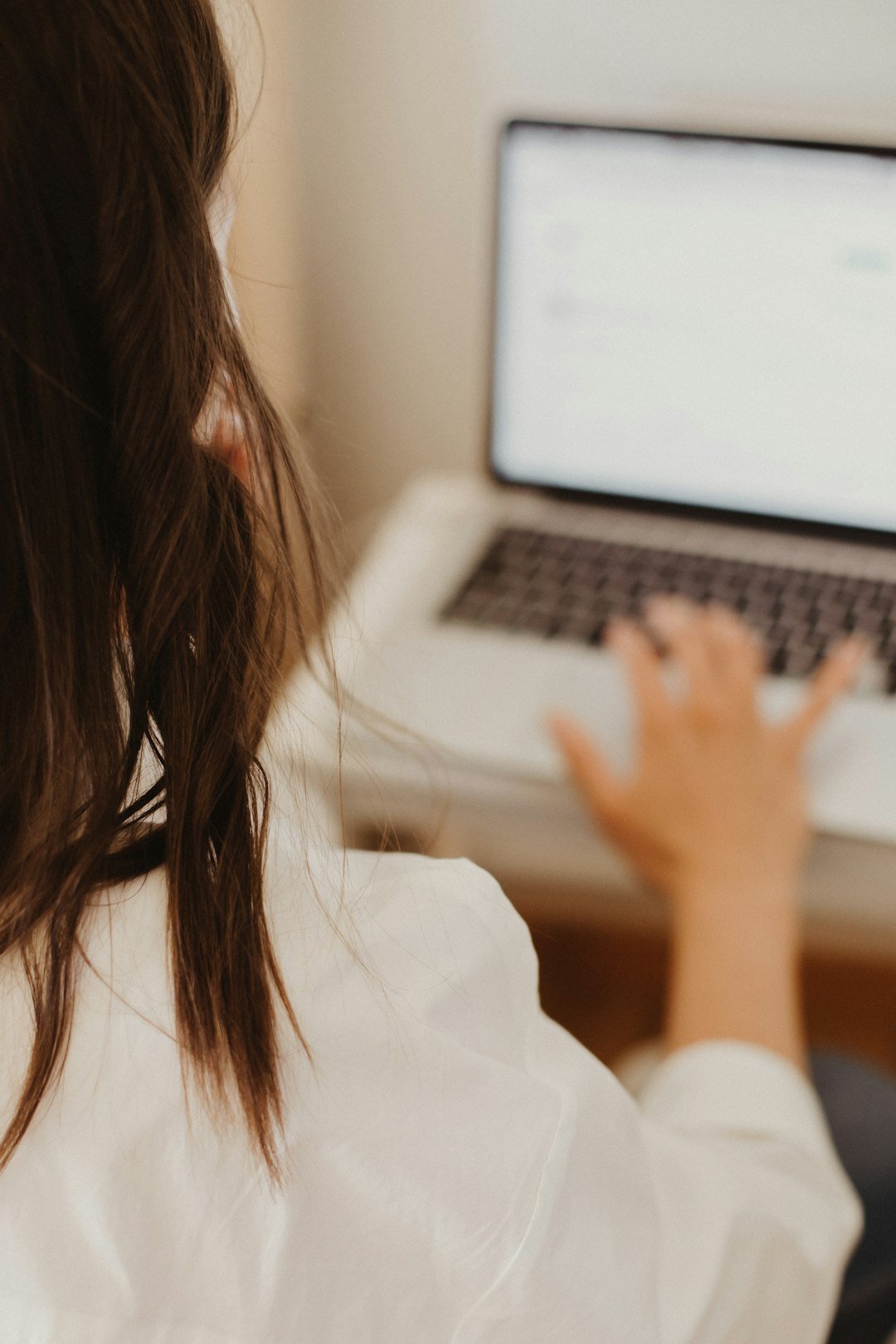 Editor typing on laptop preparing brief