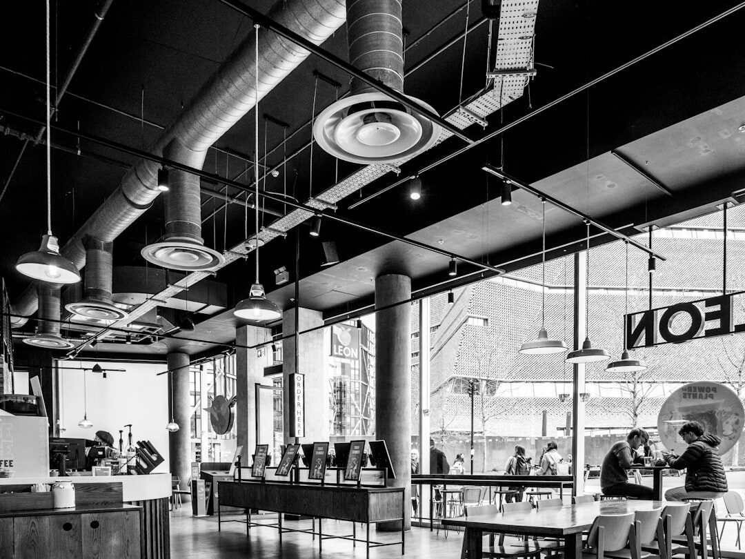 Modern newsroom workspace with desks and screens